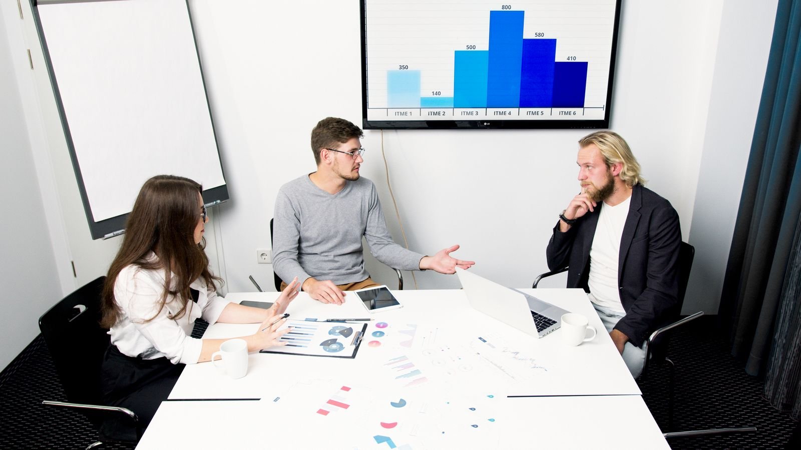 An agency team reviewing results with a client in a meeting room