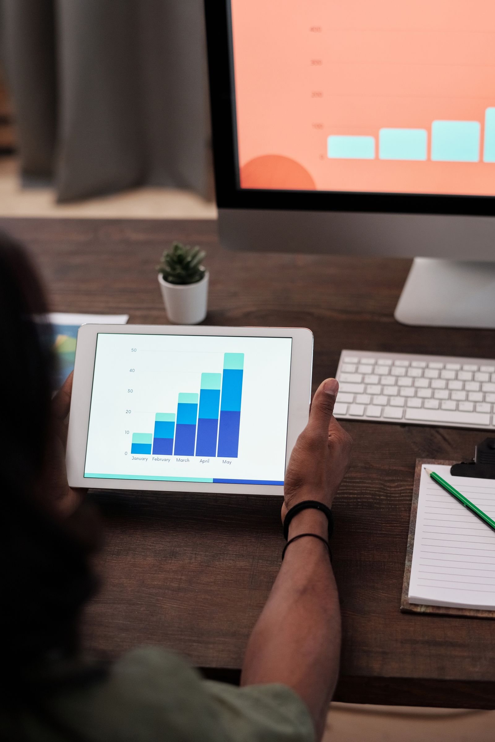 A tablet showing a rising bar chart