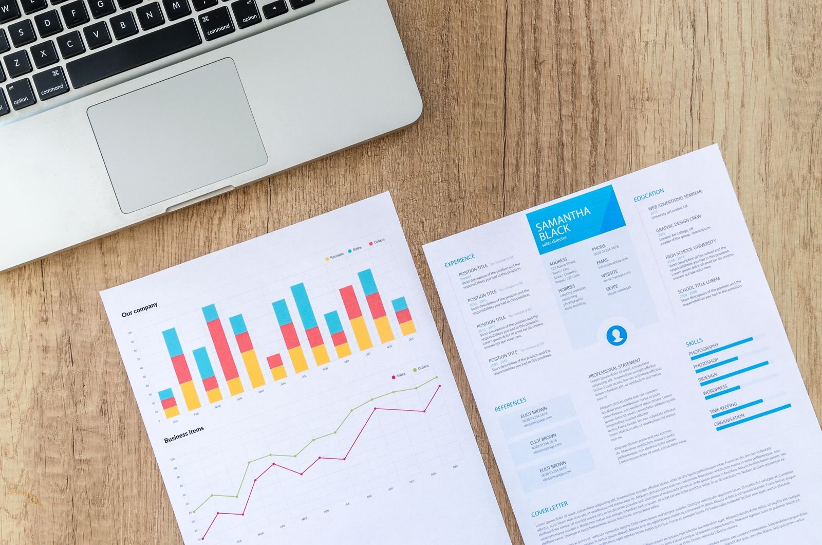 A printed marketing report with charts next to a laptop
