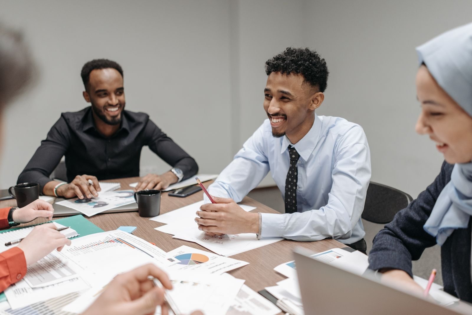 A relaxed team reviewing work together around a meeting table