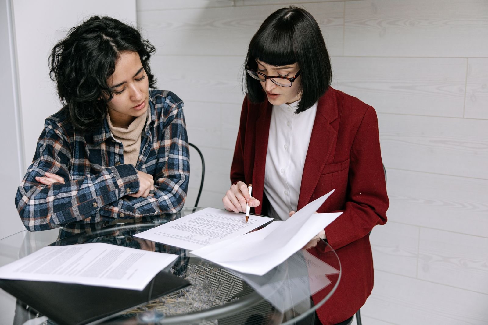 Two people reviewing a document together at a table