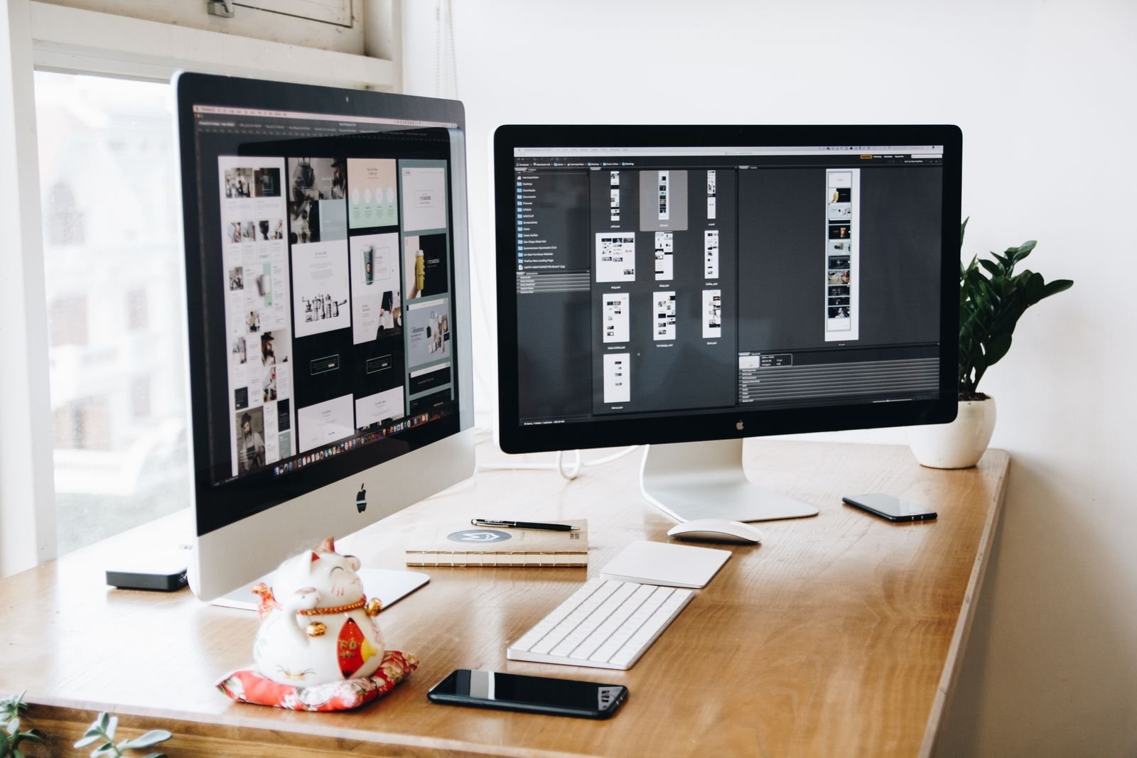 Designer workspace with page layouts on two monitors