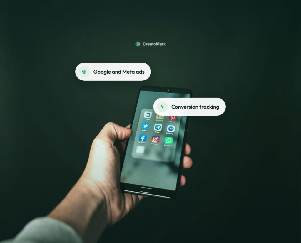 A hand holding a phone with social media apps